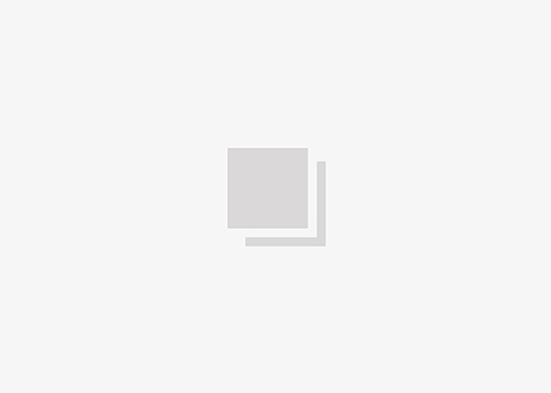 on white image of a savia sofa and a person walking next to it