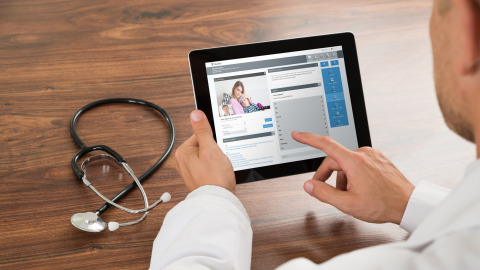 Doctor using tablet to communicate with patient virtual
