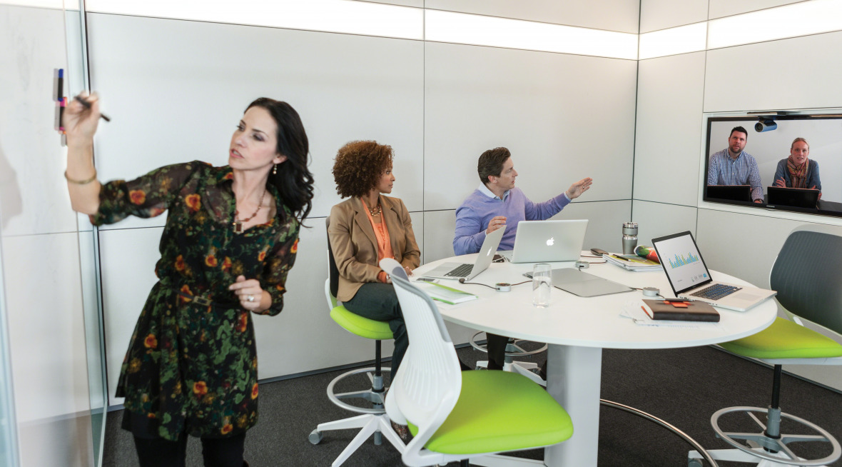 people working together in a huddle room