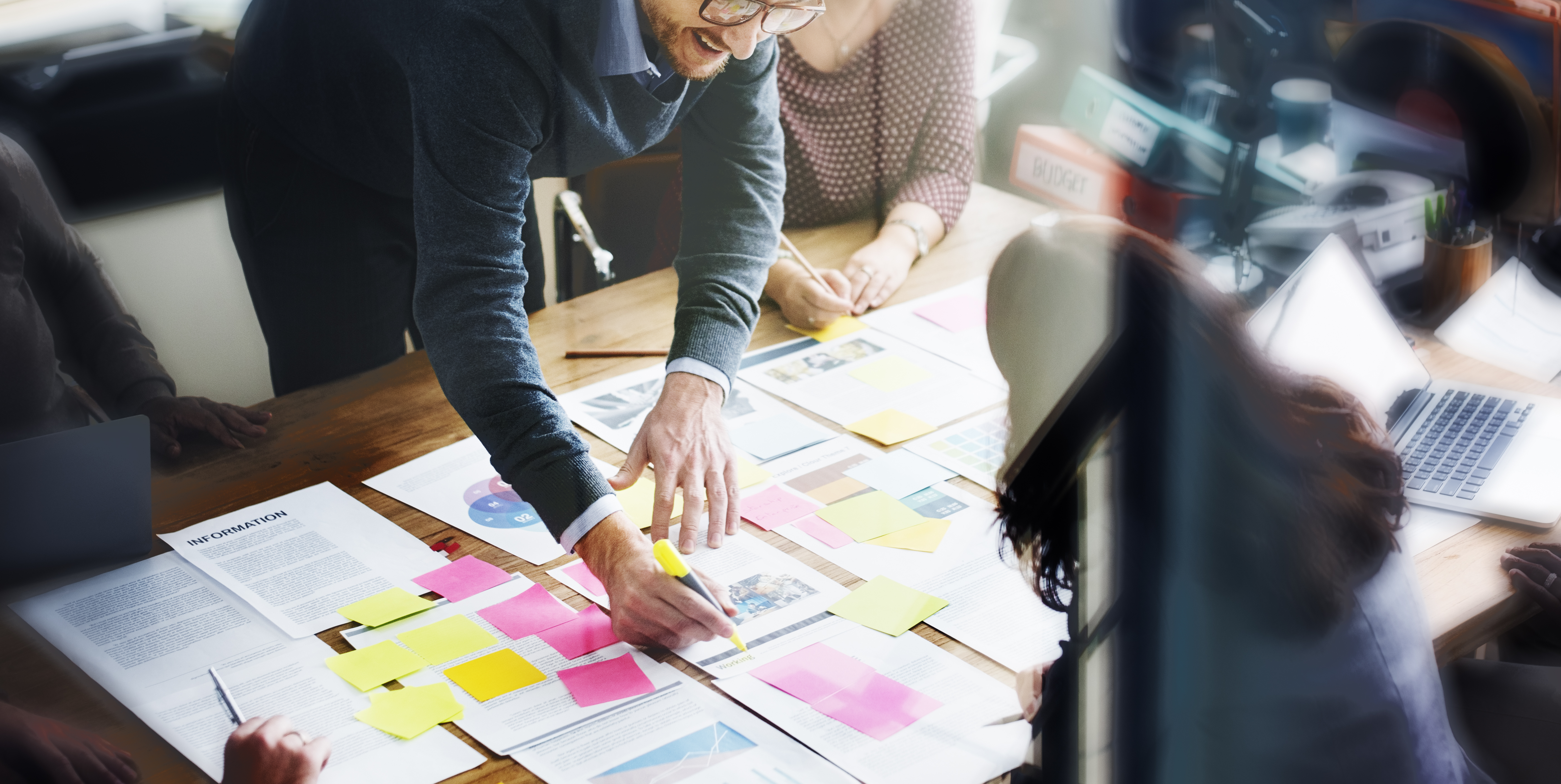 people in meeting working over table