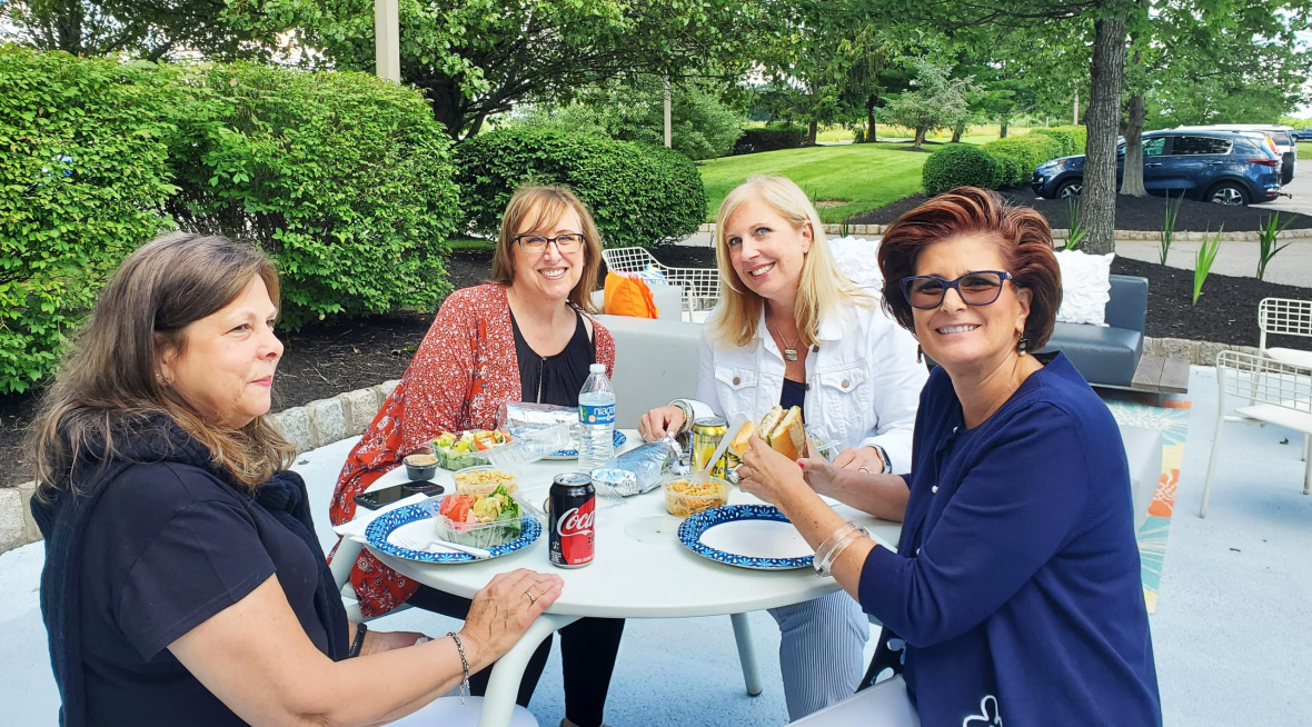 employees enjoying lunch together outside