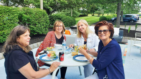employees enjoying lunch together outside