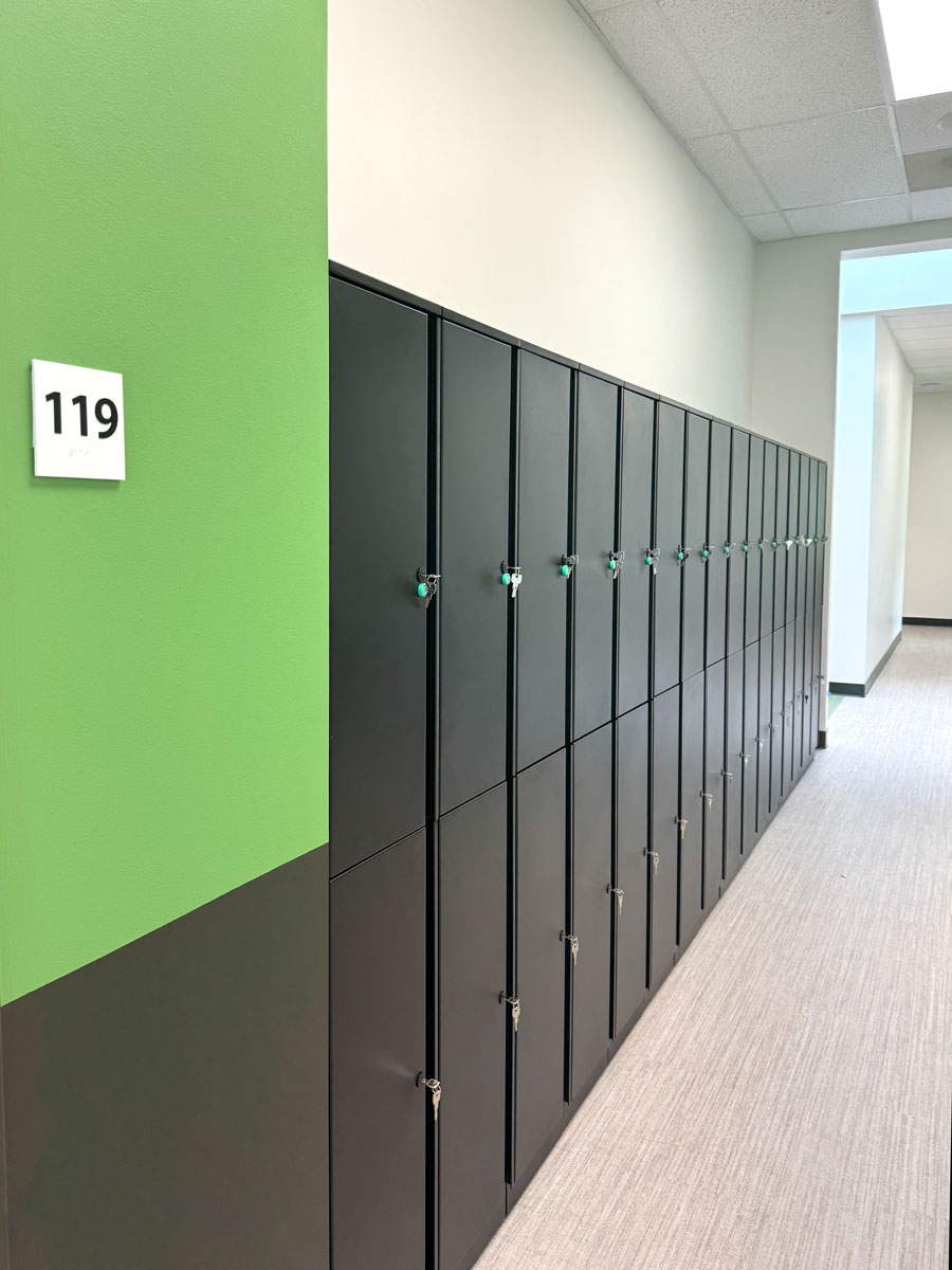 modern black lockers in a well lit school hallway